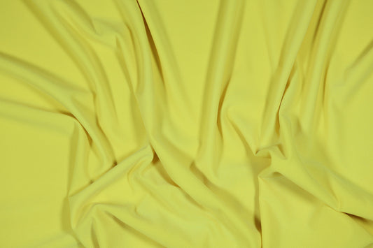Elastischer Jersey in einem hellen, sonnigen Gelbton für Sommerbekleidung