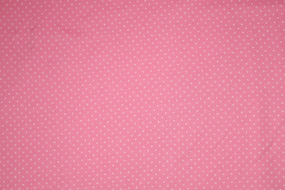 Zartes Punktmuster auf rosa Baumwollstoff – ideal für Baby- und Kinderkleidung.