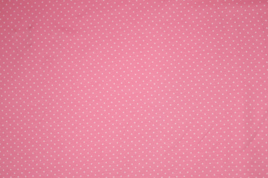 Zartes Punktmuster auf rosa Baumwollstoff – ideal für Baby- und Kinderkleidung.