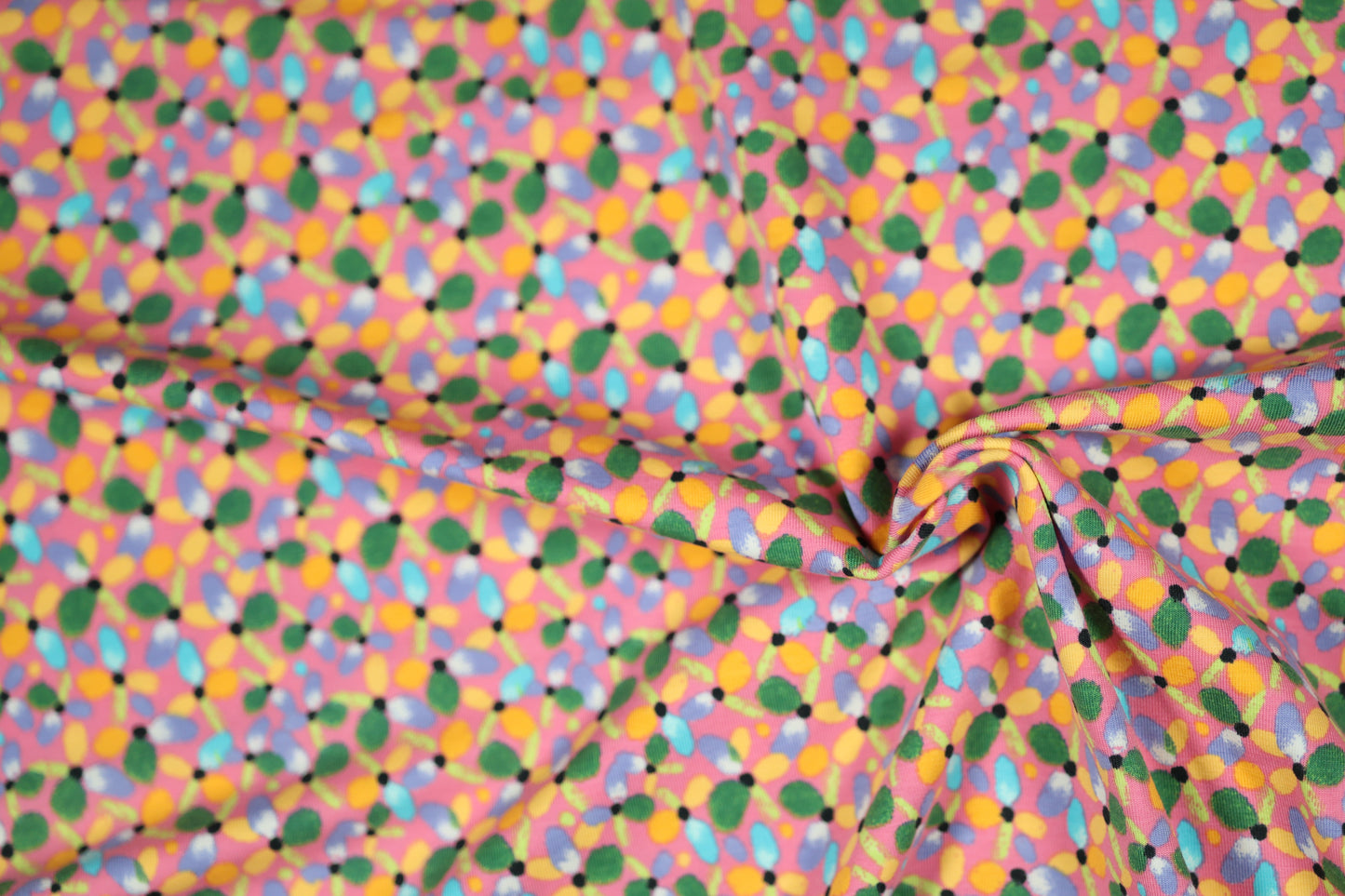 Baumwollstoff mit Motiv: bunte blüten auf rosa – weich & kindgerecht.