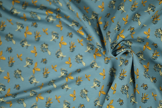 Baumwollstoff mit Motiv: gelbe blätter auf himmelblau – weich & kindgerecht.